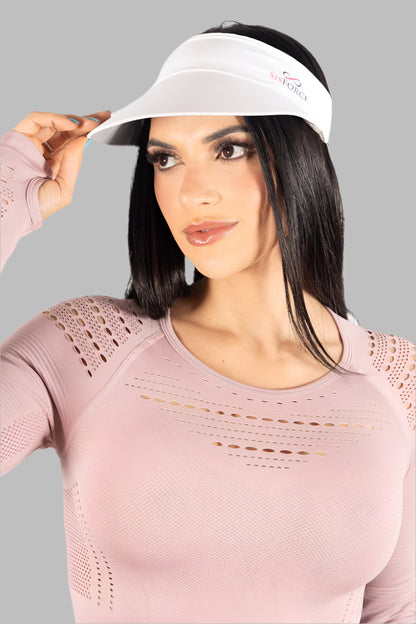 Woman wearing a pink athletic outfit with a visor against a light gray background